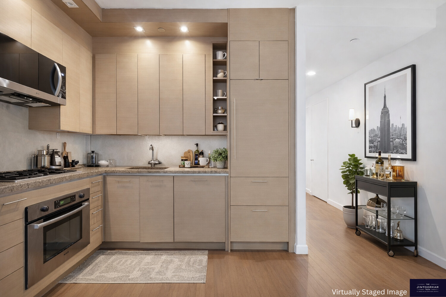 1600 Broadway, Unit 18D Manhattan, NY 10019 - Photo 4 of 5 a kitchen with granite countertop a stove a sink and a microwave