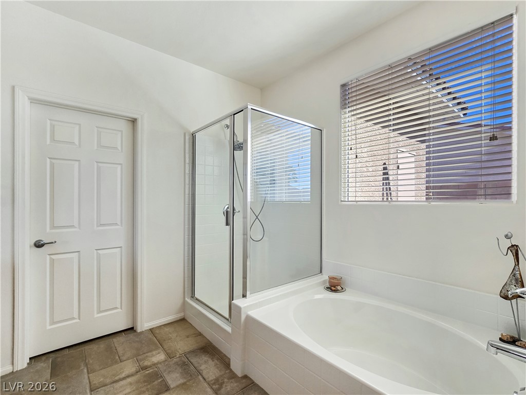 2485 Morrow Ridge Place Laughlin, NV 89029 - Photo 24 of 40 A well-appointed bathroom offers both a spacious soaking tub and a walk-in shower.