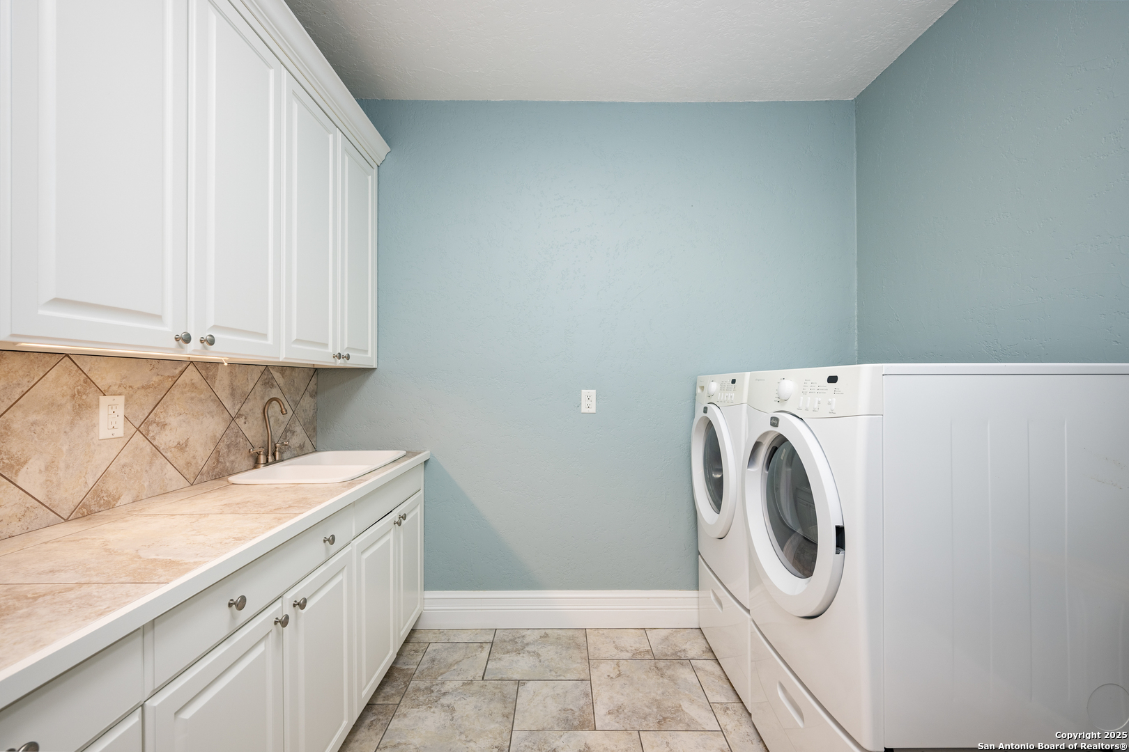 613 Saxet Trail Spring Branch, TX 78070 - Photo 11 of 41 a utility room with dryer and washer