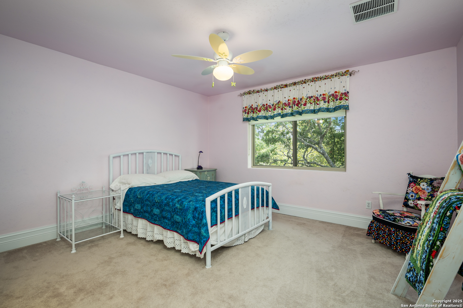 613 Saxet Trail Spring Branch, TX 78070 - Photo 22 of 41 a bedroom with a bed and a chandelier
