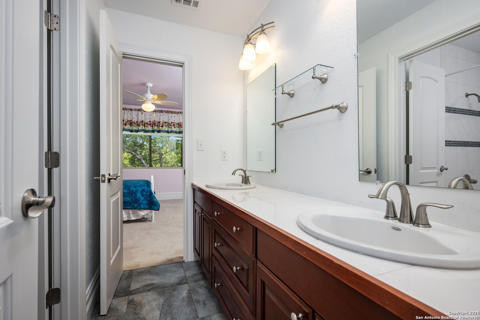 613 Saxet Trail Spring Branch, TX 78070 - Photo 23 of 41 a bathroom with a double vanity sink a mirror and shower
