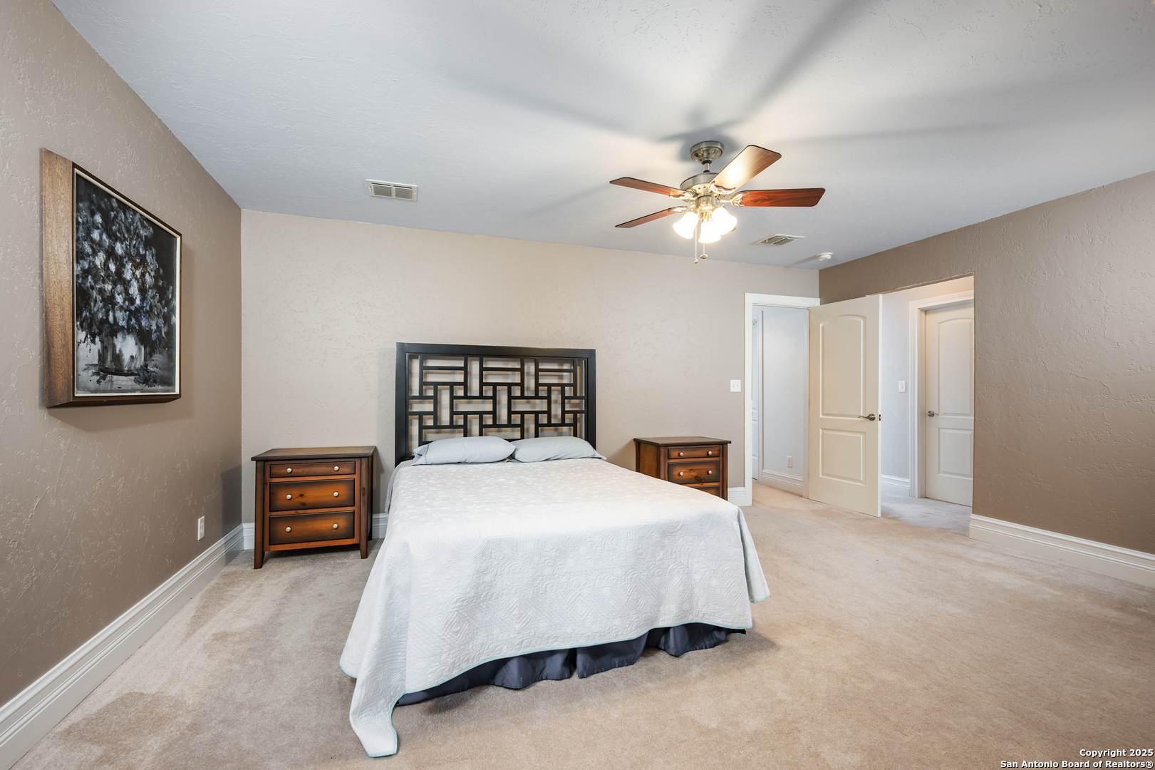 613 Saxet Trail Spring Branch, TX 78070 - Photo 27 of 41 a bedroom with a bed and a chandelier