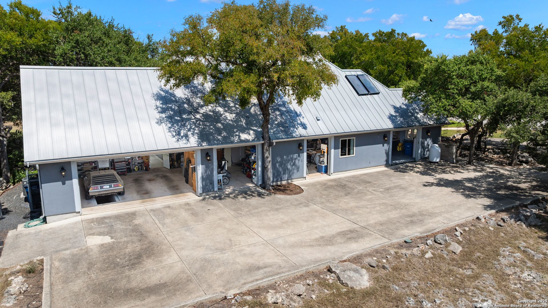 613 Saxet Trail Spring Branch, TX 78070 - Photo 38 of 41 a view of a house with a backyard and a tree