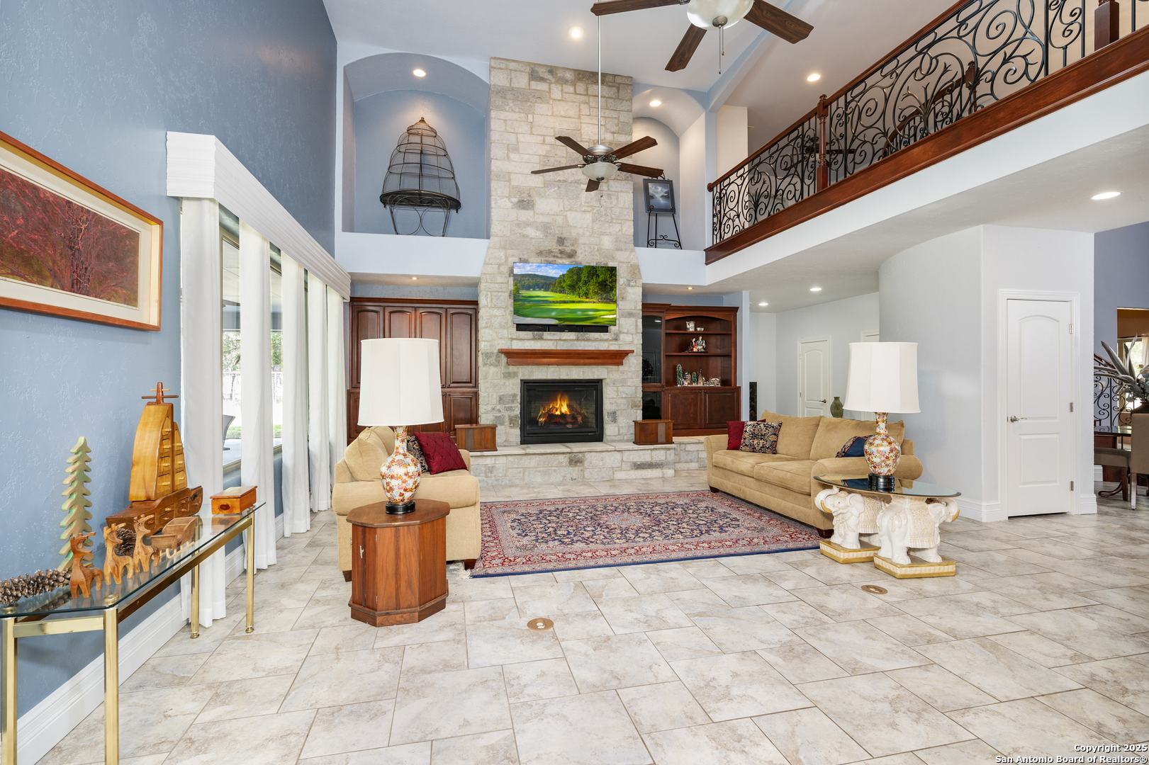 613 Saxet Trail Spring Branch, TX 78070 - Photo 6 of 41 a living room with furniture a fireplace and a chandelier