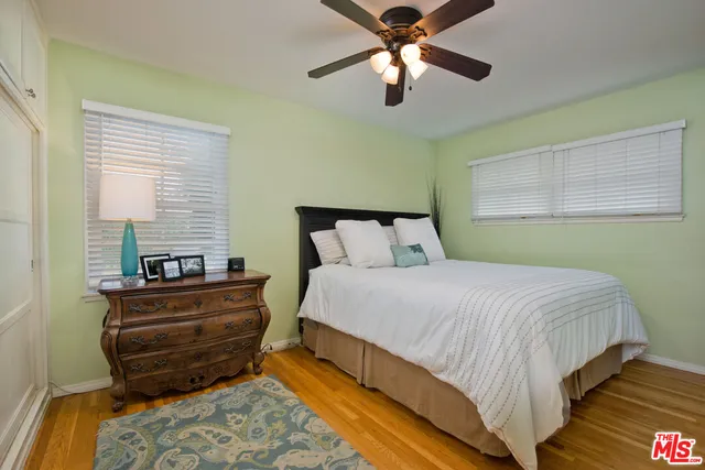 a bedroom with bed and window