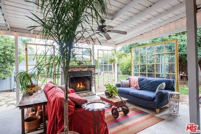 a living room with furniture a fireplace and a large window