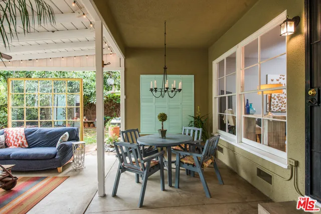 a dining room with furniture a rug and a large window