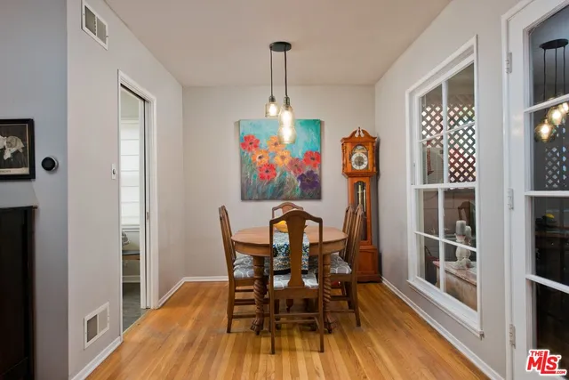 a view of a dining room with furniture window and wooden floor