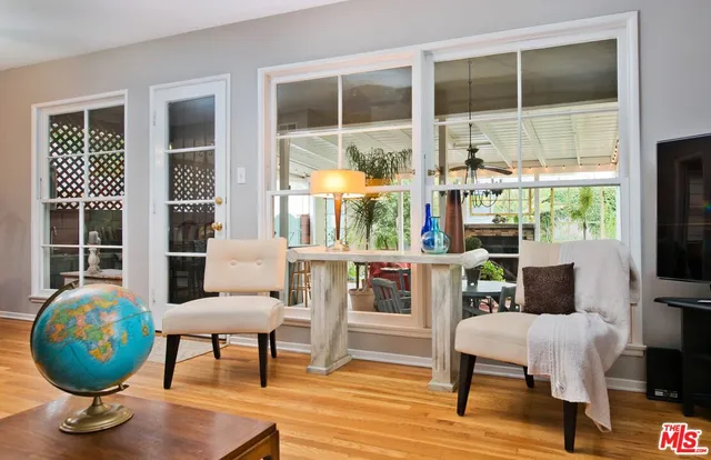 a view of a livingroom with furniture and a large window