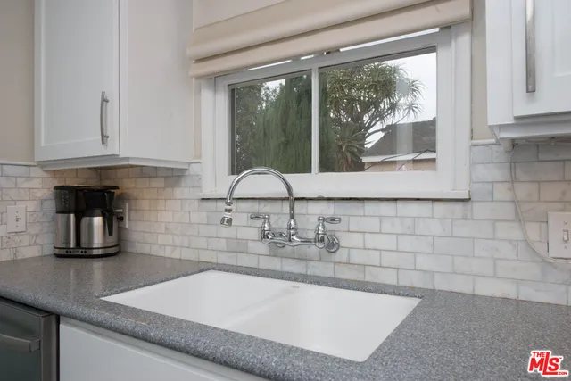 a kitchen with granite countertop a sink and a window
