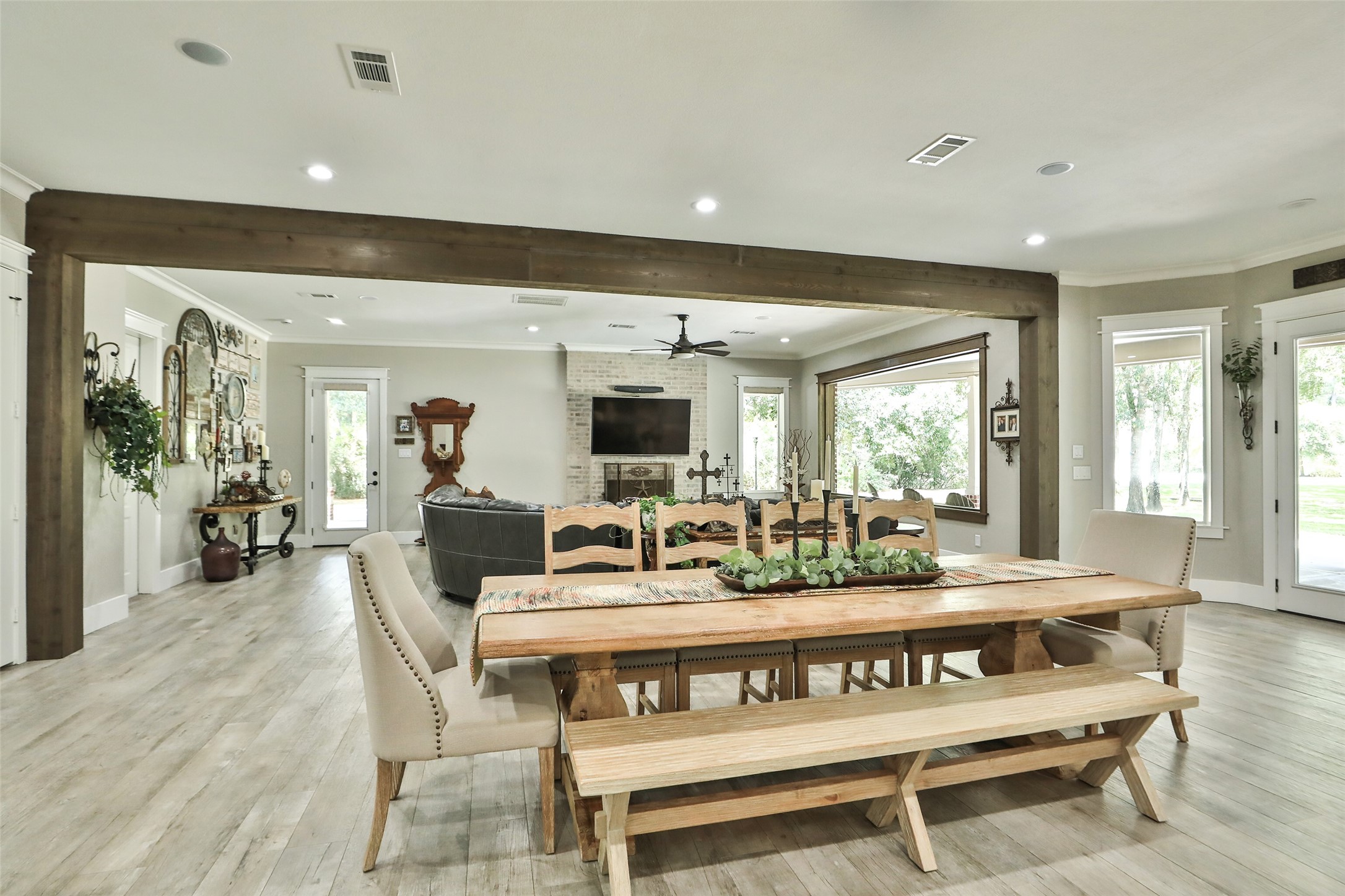 12126 Zion Road Tomball, TX 77375 - Photo 16 of 45 Picture perfect and filled with natural light! The dining and living rooms showcase stunning walls of windows that create a bright, airy atmosphere and offer beautiful views of the outdoors.