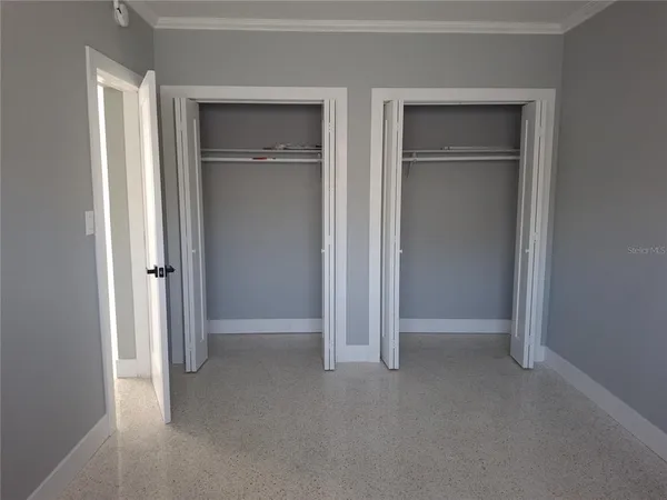 a view of an empty room with closet area