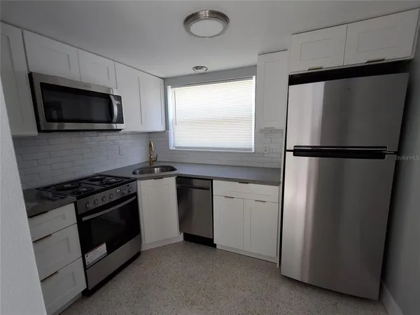 a kitchen with a stove and a microwave