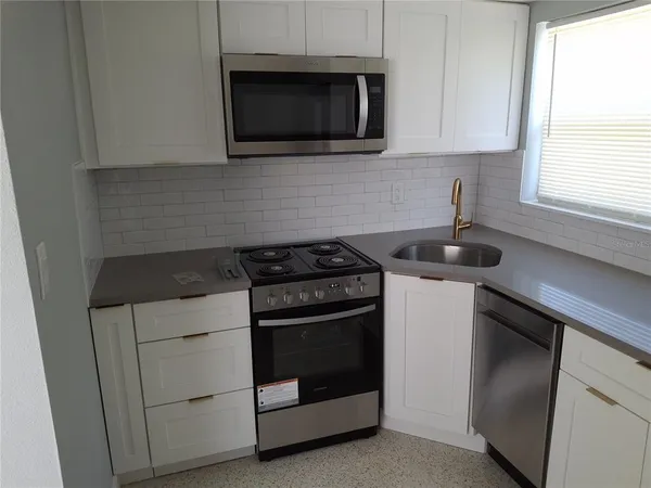 a kitchen with a refrigerator and window