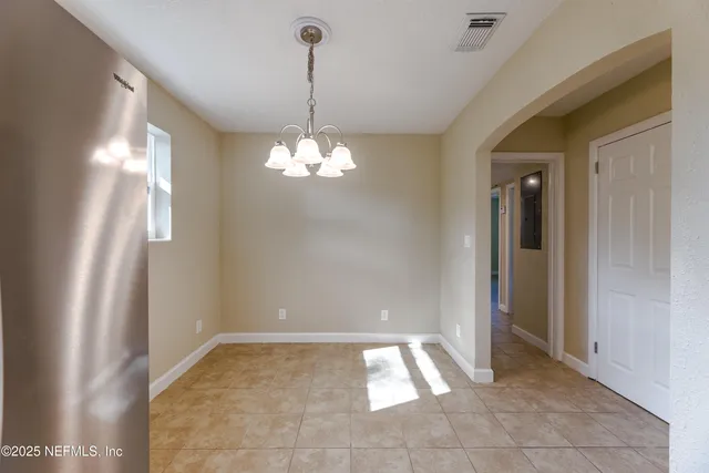 a kitchen with a refrigerator a sink and cabinets