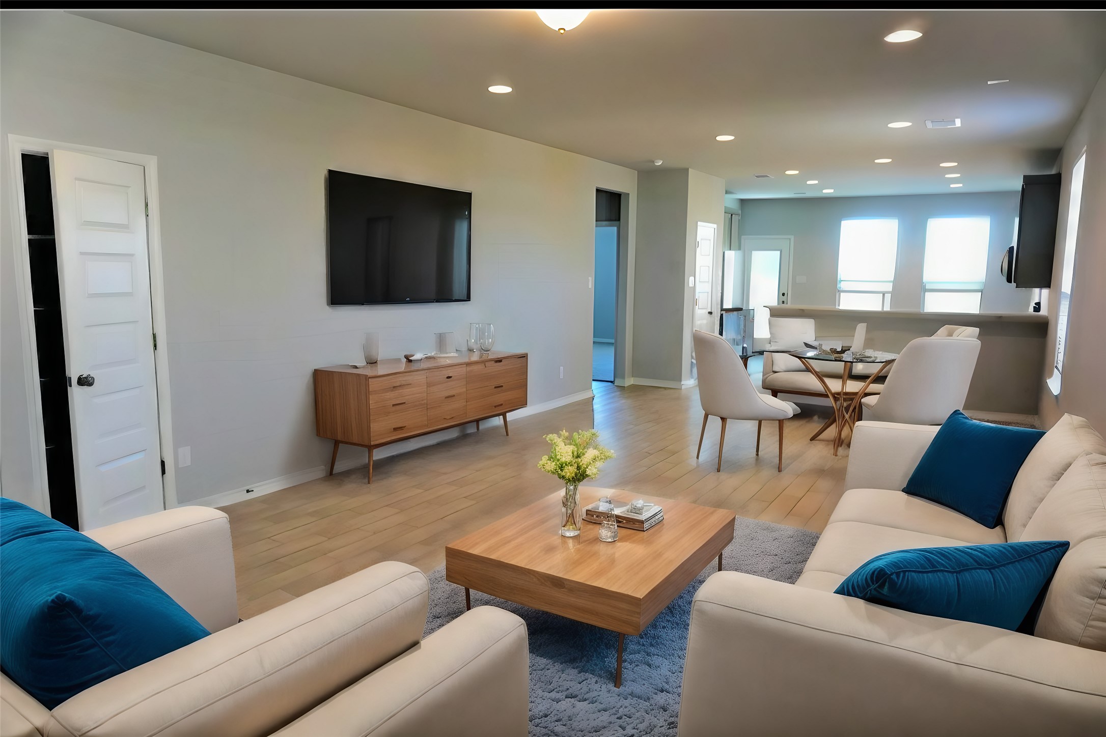 104 Batjac Alley Jarrell, TX 76537 - Photo 2 of 11 Open-concept living space featuring wood-finish flooring, recessed lighting, and light gray wall tones