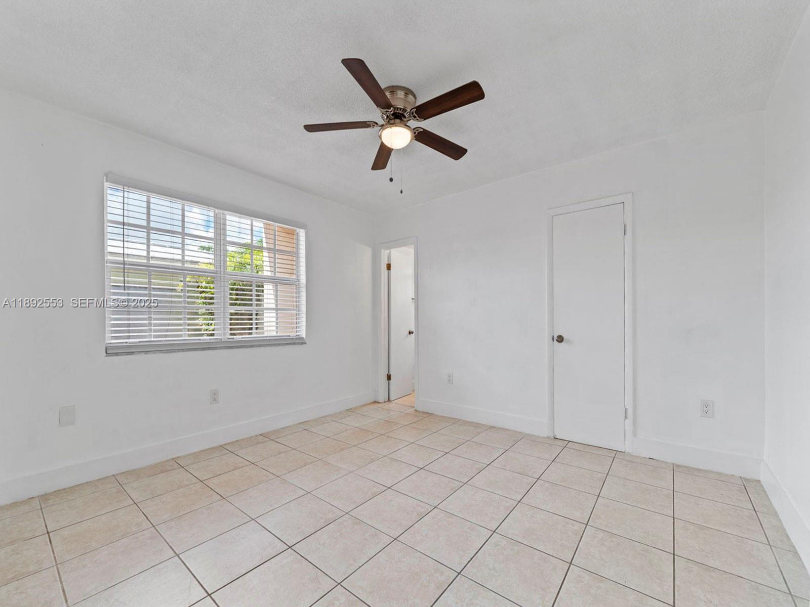 9100 Southwest 95th Avenue, Unit 9100 Miami, FL 33176 - Photo 15 of 37 a view of an empty room with a window