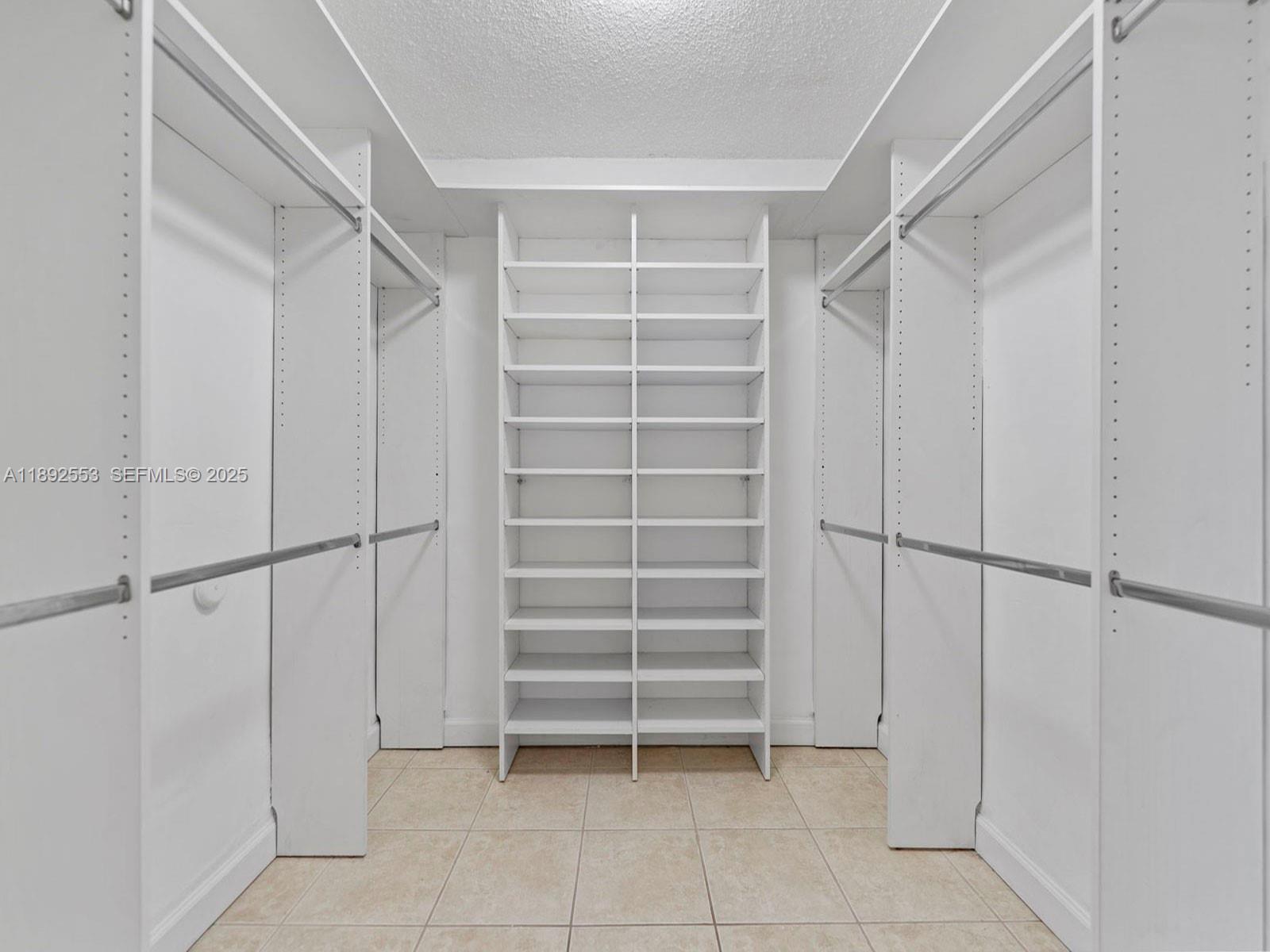 9100 Southwest 95th Avenue, Unit 9100 Miami, FL 33176 - Photo 16 of 37 a view of walk in closet with empty racks