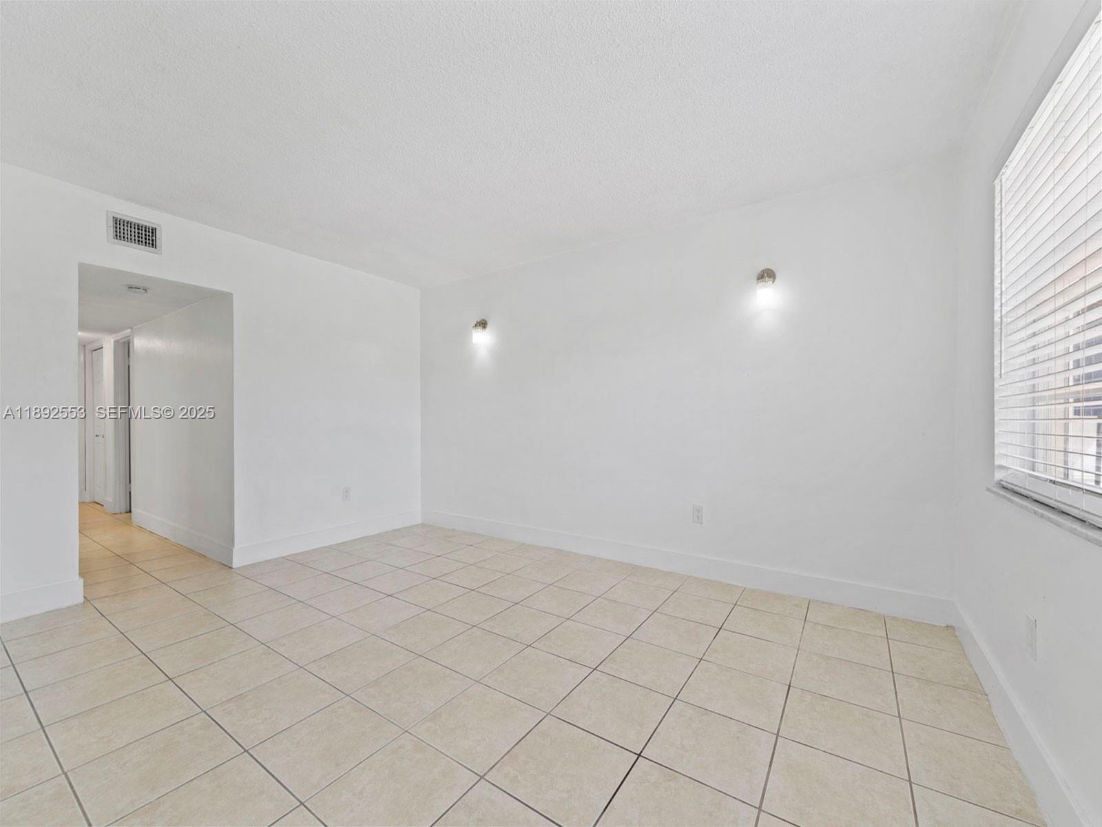 9100 Southwest 95th Avenue, Unit 9100 Miami, FL 33176 - Photo 18 of 37 an empty room with white walls and tiles
