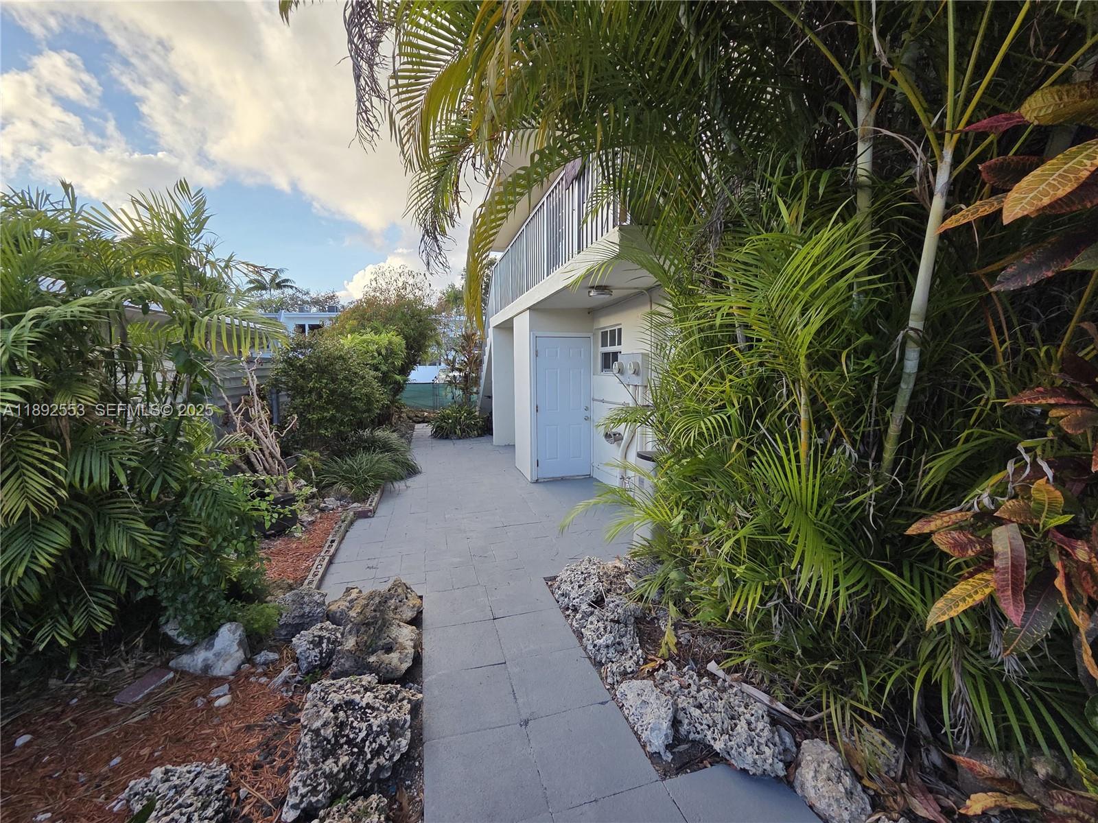 9100 Southwest 95th Avenue, Unit 9100 Miami, FL 33176 - Photo 27 of 37 a backyard of a house with lots of green space