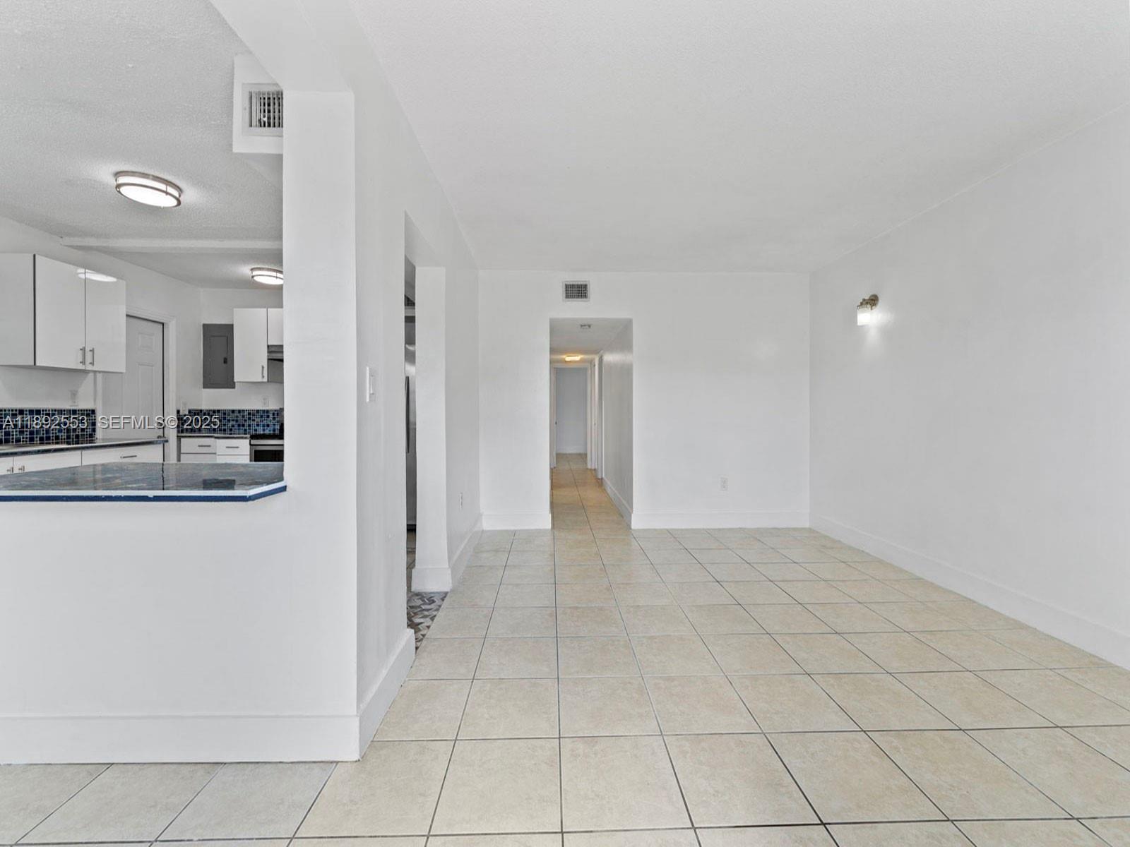 9100 Southwest 95th Avenue, Unit 9100 Miami, FL 33176 - Photo 5 of 37 a view of a kitchen with an empty space and a window