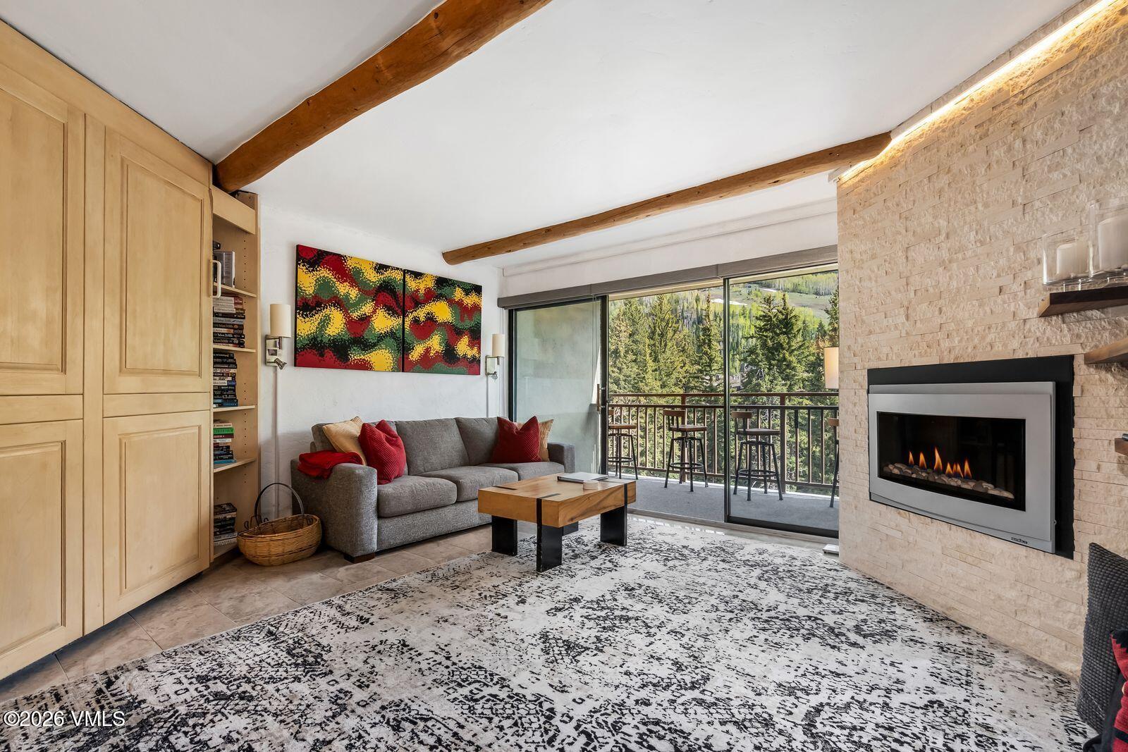 500 South Frontage Road East, Unit 308 Vail, CO 81657 - Photo 2 of 25 a living room with furniture and a fireplace