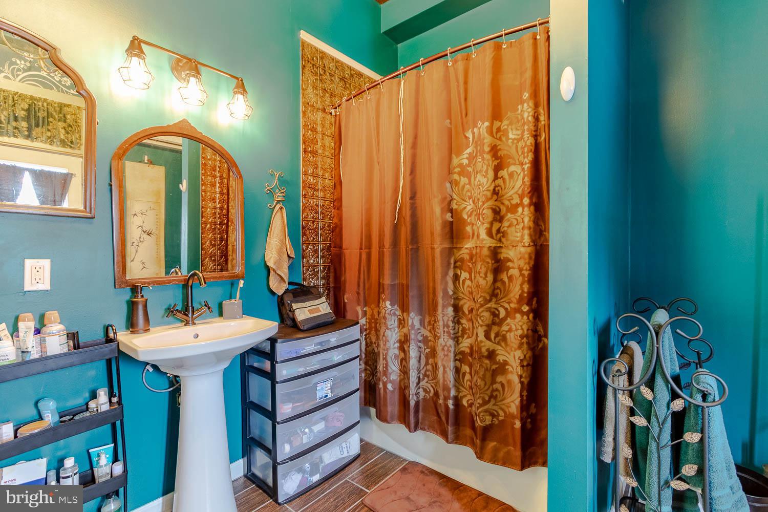 1070 Valley View Road Bellefonte, PA 16823 - Photo 38 of 52 a bathroom with a sink a mirror and a window
