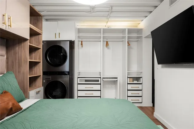 a view of walk in closet with clothes and shoes