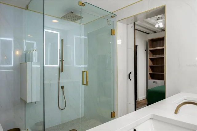 a bathroom with a shower and a sink
