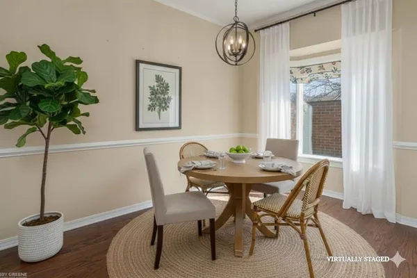 a view of a dining room with furniture and wooden floor