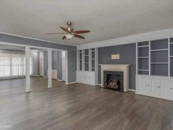 a view of an empty room with a fireplace and a window