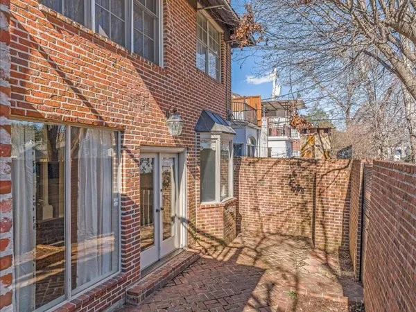 a view of a brick house with large windows