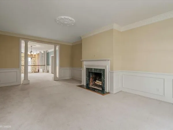 a view of an empty room with a fireplace and a window