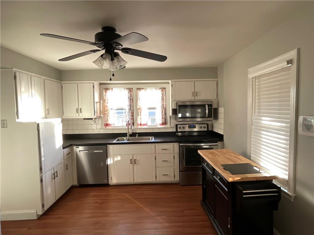 809 Locust Avenue Washington, PA 15301 - Photo 12 of 27 a kitchen with granite countertop stainless steel appliances a sink cabinets and wooden floor