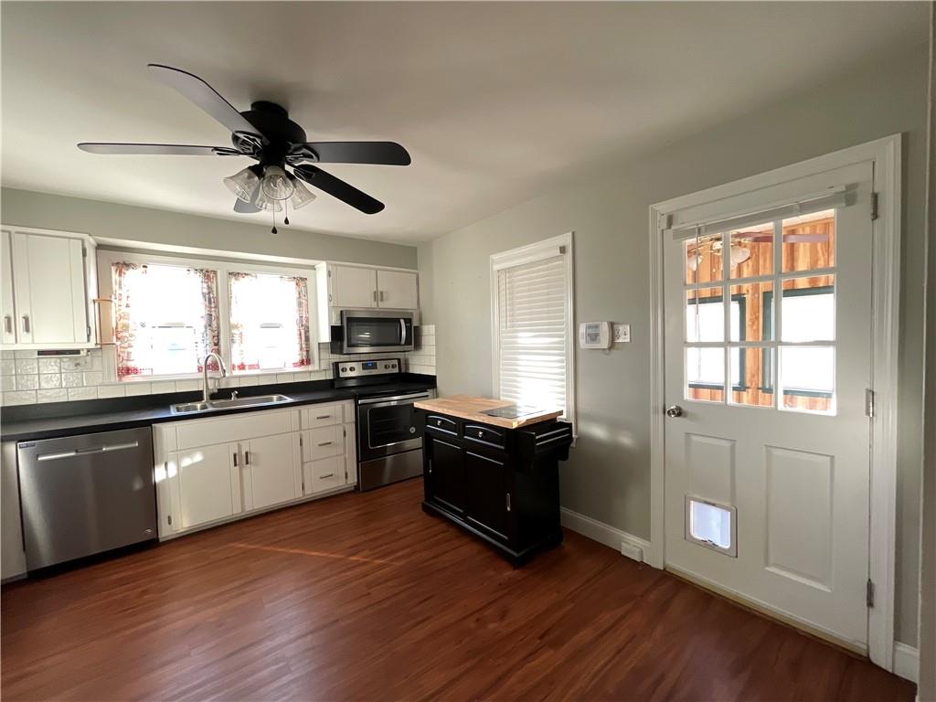 809 Locust Avenue Washington, PA 15301 - Photo 14 of 27 a kitchen with granite countertop stainless steel appliances a stove and wooden floor