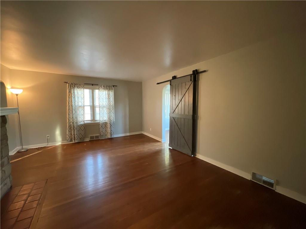 809 Locust Avenue Washington, PA 15301 - Photo 10 of 27 an empty room with wooden floor and windows