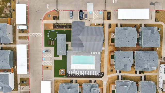 an aerial view of residential houses with outdoor space