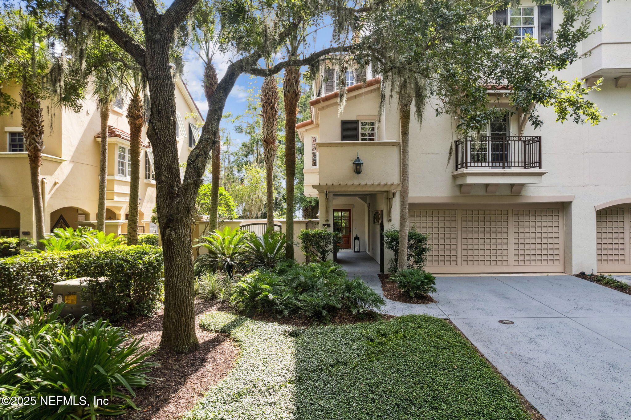 95032 Spring Tide Lane Fernandina Beach, FL 32034 - Photo 1 of 50 a front view of a house with garden