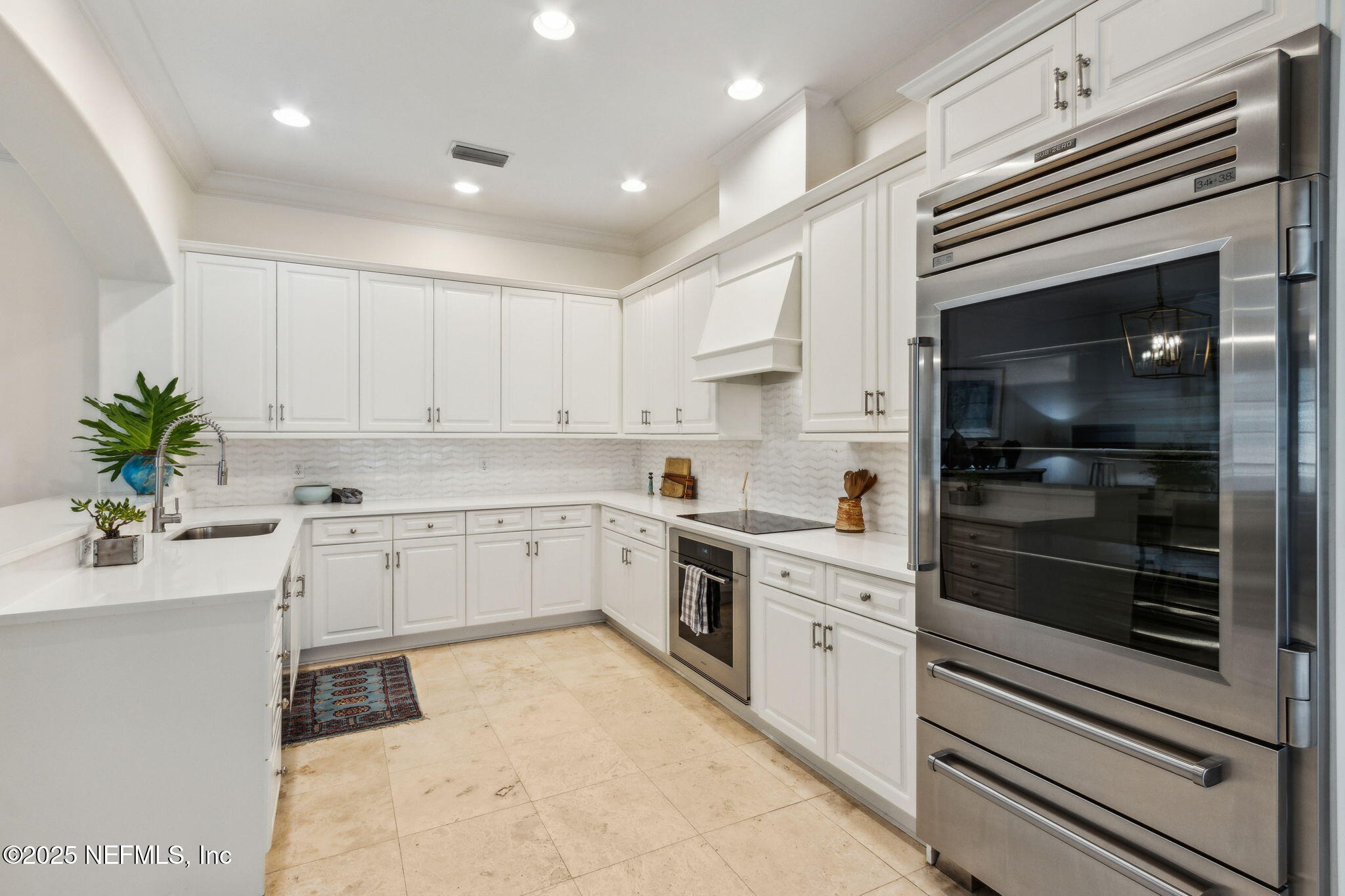 95032 Spring Tide Lane Fernandina Beach, FL 32034 - Photo 15 of 50 a kitchen with white cabinets and white appliances