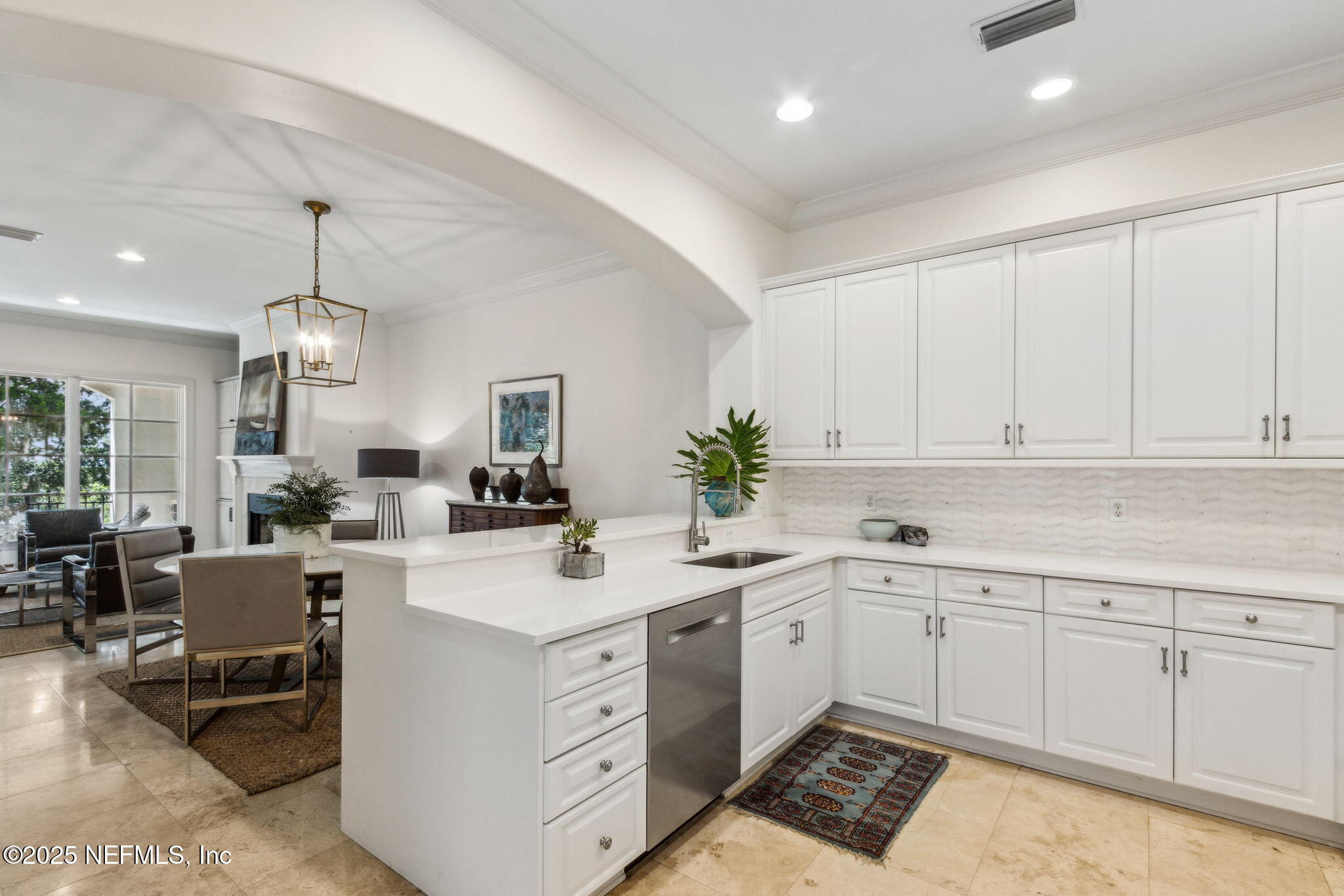 95032 Spring Tide Lane Fernandina Beach, FL 32034 - Photo 17 of 50 a kitchen with a sink dishwasher a stove a dining table and chairs