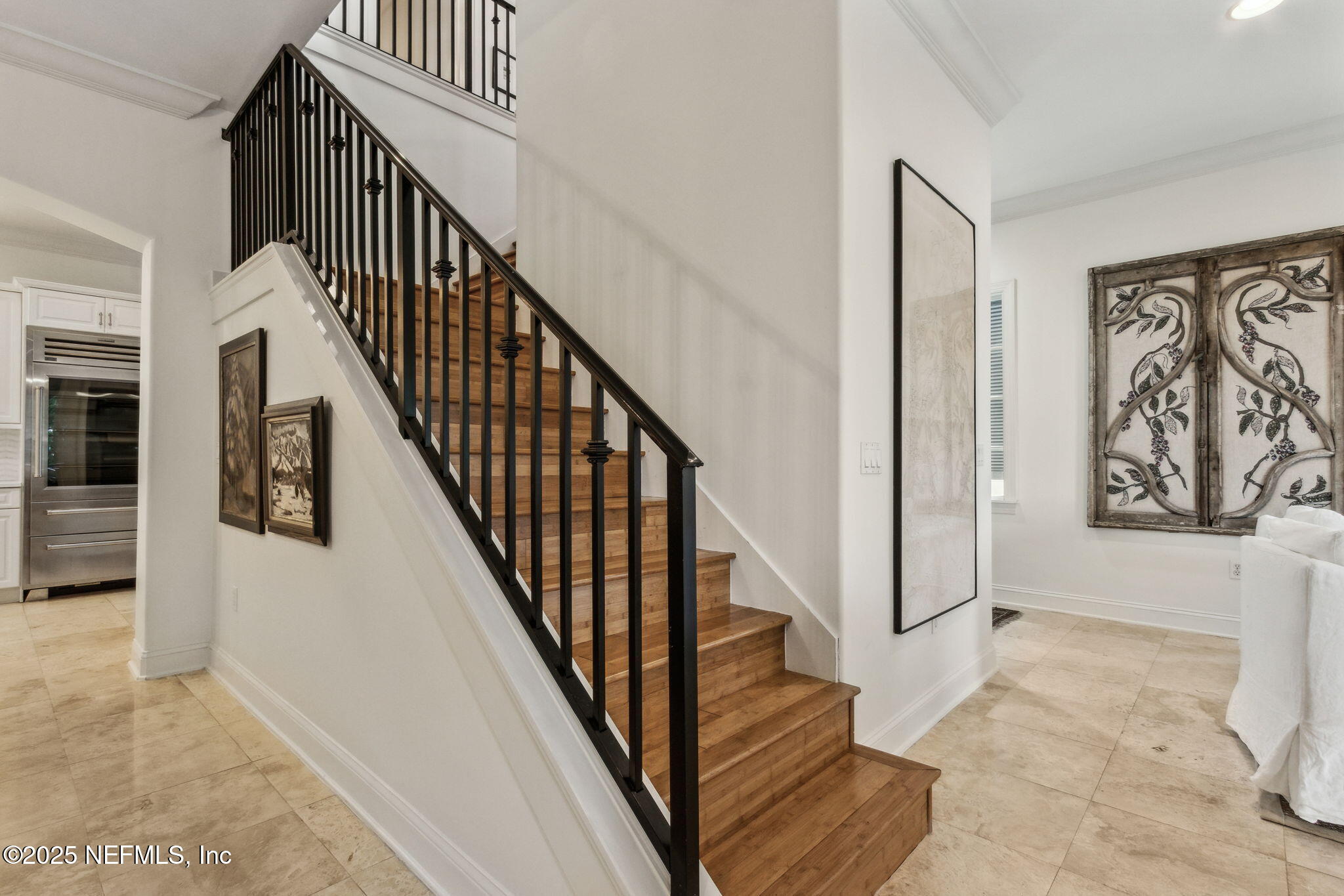 95032 Spring Tide Lane Fernandina Beach, FL 32034 - Photo 25 of 50 a view of staircase with lots of frames on wall and a window