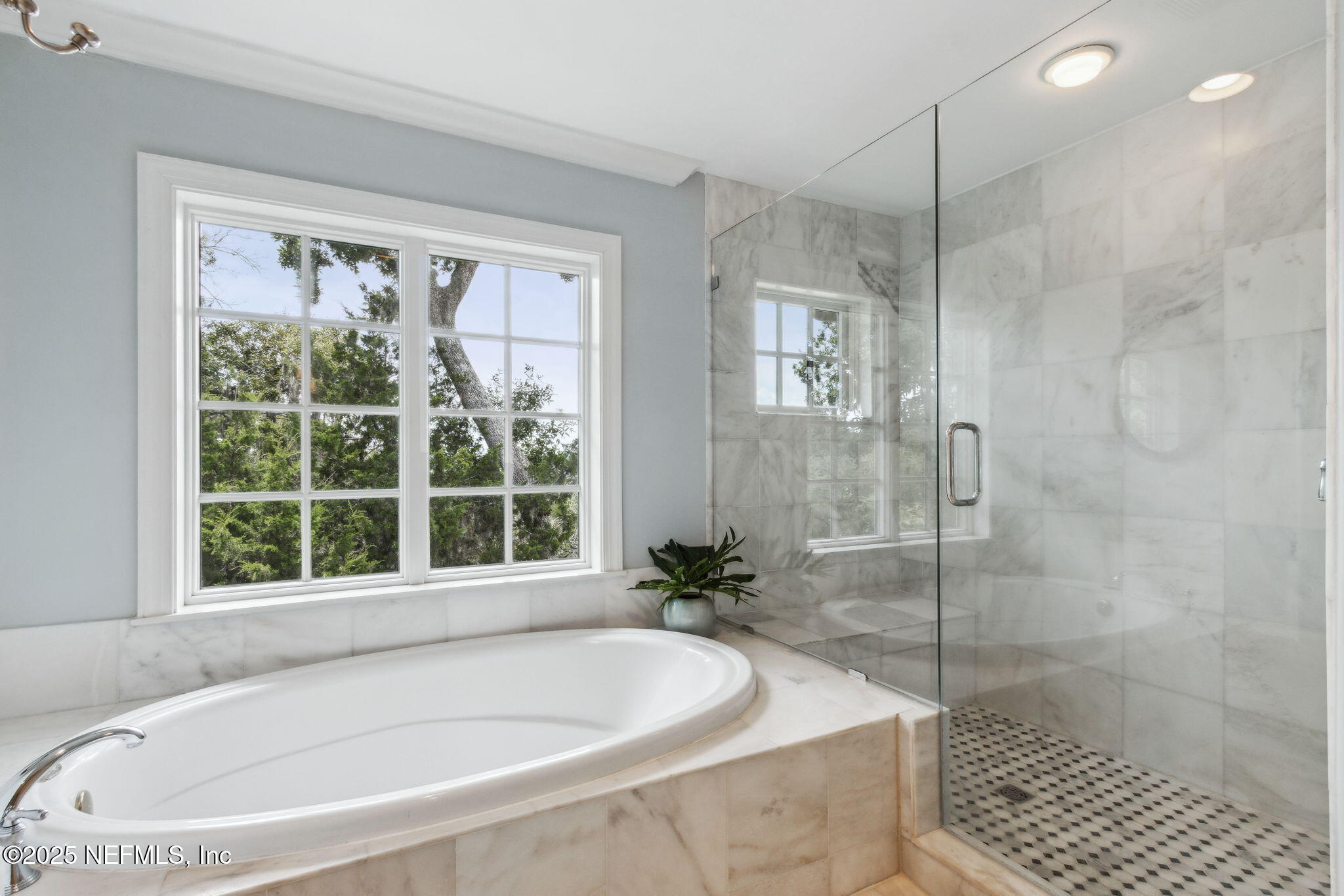 95032 Spring Tide Lane Fernandina Beach, FL 32034 - Photo 29 of 50 a white bath tub sitting in a bathroom next to a window