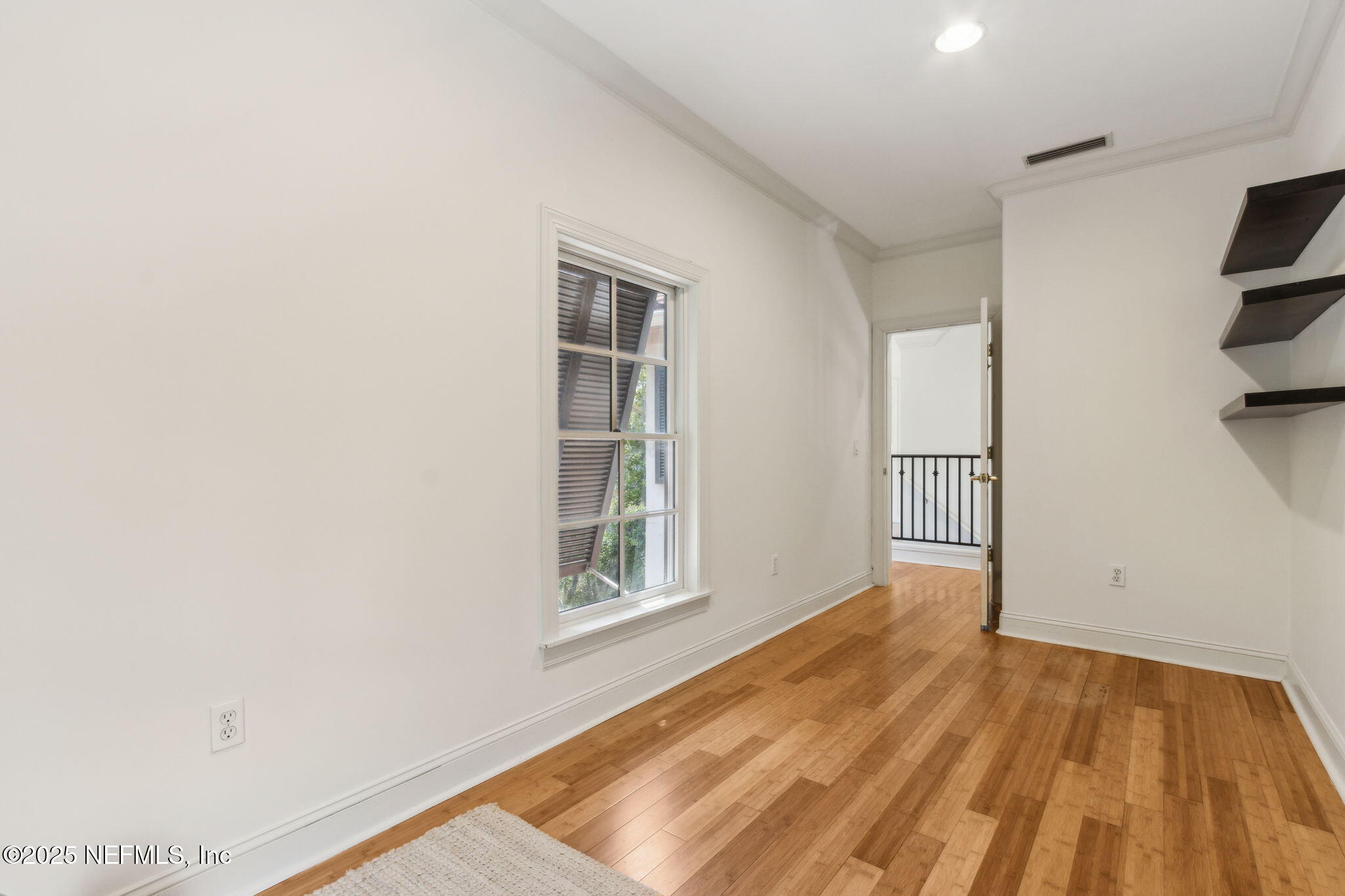 95032 Spring Tide Lane Fernandina Beach, FL 32034 - Photo 36 of 50 a view of empty room with wooden floor and fan