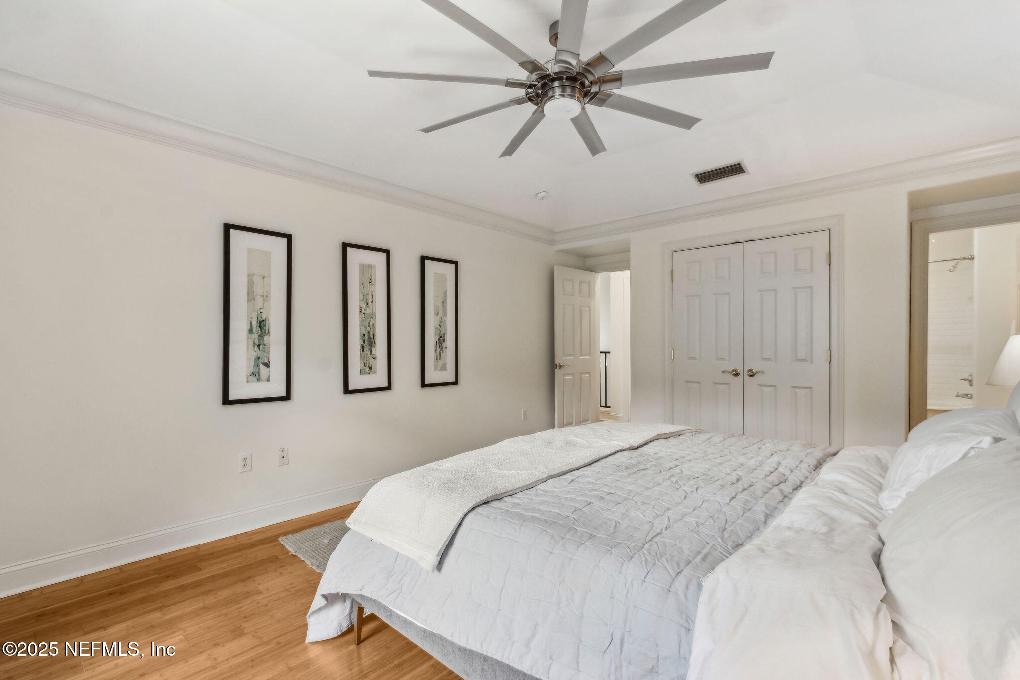 95032 Spring Tide Lane Fernandina Beach, FL 32034 - Photo 38 of 50 a bedroom with a large bed chandelier and a window