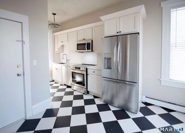 a kitchen with stainless steel appliances a refrigerator and cabinets