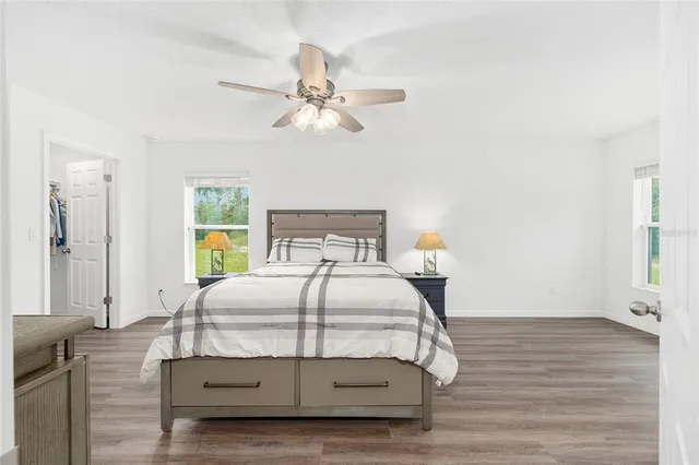 a bedroom with a bed window and a chandelier