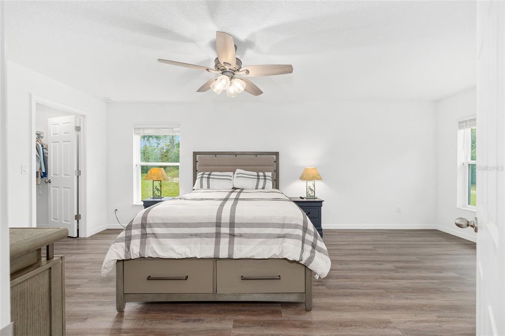 8381 North Wayside Avenue Dunnellon, FL 34433 - Photo 11 of 37 a bedroom with a bed window and a chandelier