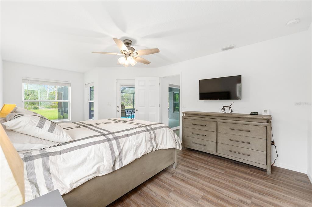 8381 North Wayside Avenue Dunnellon, FL 34433 - Photo 12 of 37 a spacious bedroom with a bed and a flat screen tv