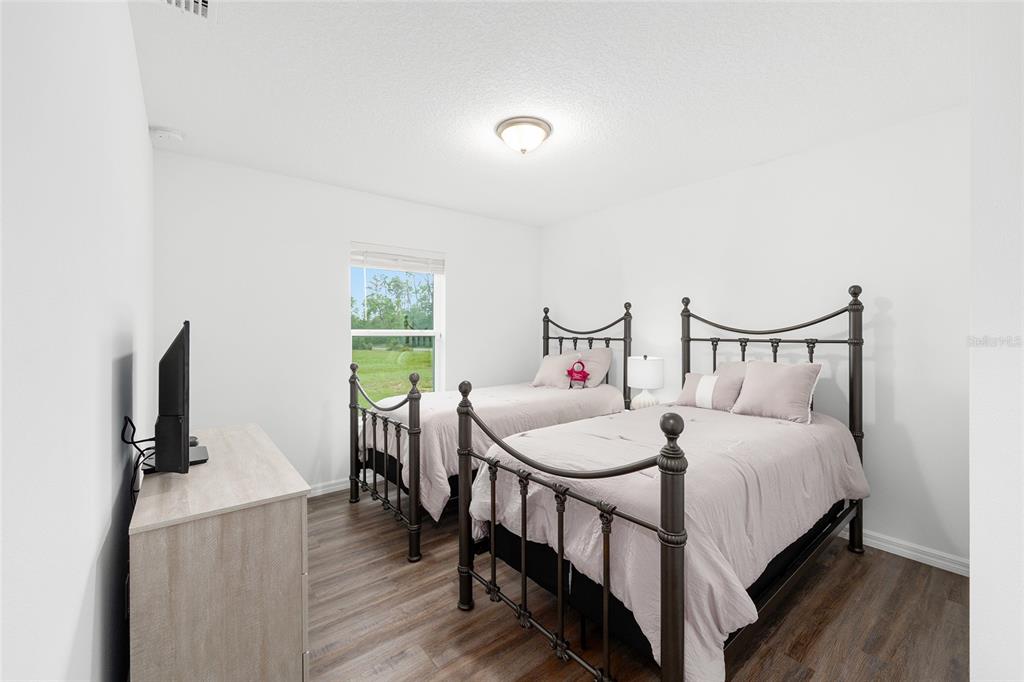 8381 North Wayside Avenue Dunnellon, FL 34433 - Photo 16 of 37 a bedroom with a bed and a flat tv screen on a dresser