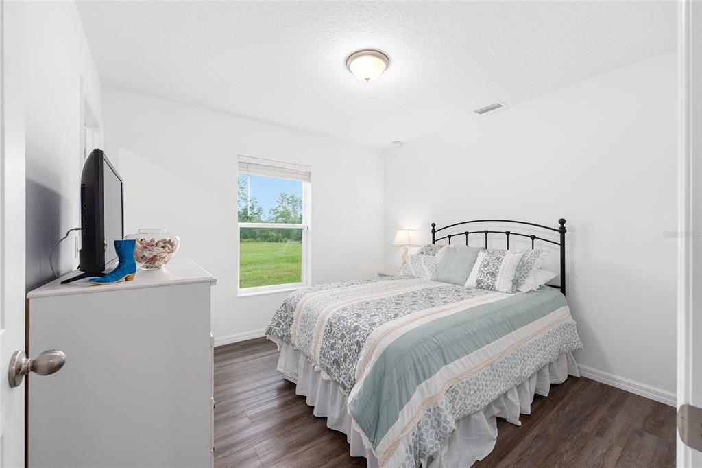 8381 North Wayside Avenue Dunnellon, FL 34433 - Photo 20 of 37 a bedroom with a bed and a mirror